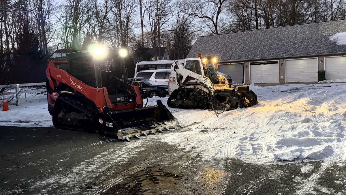 IronHaul Co fleet - Kubota and Bobcat compact track loaders working together on a job site in Fredericksburg VA