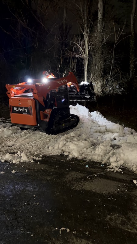 Kubota skid steer working on residential driveway in Fredericksburg VA